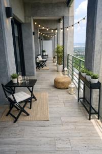 a patio with tables and chairs on a building at Garden views in Juriquilla
