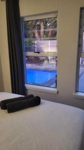 a bedroom with a bed with a window at Frankie's Nest in Cape Town +14 photos