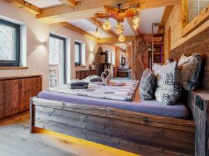 a bedroom with a large bed on a wooden platform at Bergromantik Ferienwohnung Harmonie mit Sauna, Whirlpool und Bergblick in Marktschellenberg