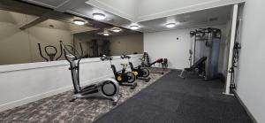 a gym with several exercise bikes and a mirror at Rayland Hotel in The Dalles