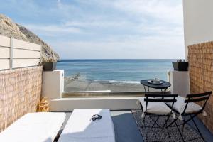 a balcony with a view of the ocean at Golden Secret Beach House in Perissa