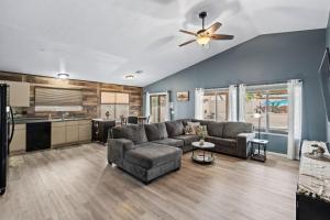 a living room with a couch and a ceiling fan at Private Pool & Fire Pit: Tucson Home Near Hiking! in Tortolita