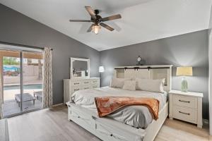 a bedroom with a bed and a ceiling fan at Private Pool & Fire Pit: Tucson Home Near Hiking! in Tortolita +30 photos