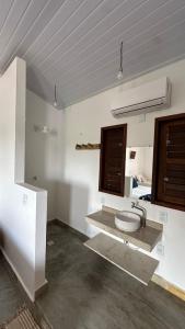 a bathroom with a sink and a toilet in a room at villa coqueiro praia do prea in Cruz +19 photos