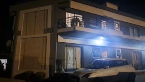 a white car parked in front of a house at Lemao guesthouse in Johannesburg