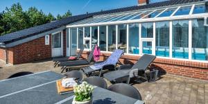 a group of chairs and tables on a patio at VE400-Vejers-Strand-Engesovej-52 in Vejers Strand