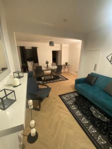 a living room with a blue couch and chairs at Alliance house OVER 25 ONLY kids with adults allowed in Belfast