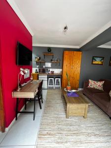 a living room with a red accent wall at Bird Song in Roodepoort