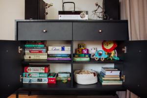 a black book shelf with books and toys on it at Pod Twisterem in Bielsko-Biała