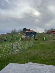 a park with a playground in a field at Šebovina Jelova gora in Starčevići