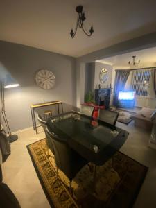 a living room with a table in the middle of a room at Manor House OVER 25 ONLY kids with adults allowed in Belfast
