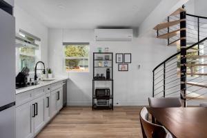 a kitchen with white cabinets and a spiral staircase at Spacious w/ 2BR 1Bath - Big Bear in Big Bear City