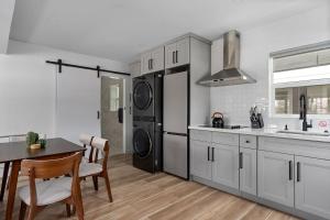 a kitchen with a refrigerator and a table with chairs at Spacious w/ 2BR 1Bath - Big Bear in Big Bear City +1 photo