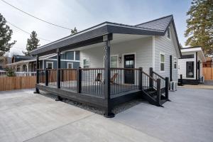 a house with a porch with a dog sitting on it at Spacious w/ 2BR 1Bath - Big Bear in Big Bear City