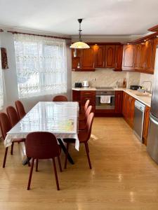 a kitchen with a table and chairs and a table and a kitchen at Apartment VEDA - Апартамент ВЕДА in Veliko Tŭrnovo