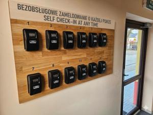 a wall display of cell phones on a wall at Hotelik SJ - bezkontaktowe zameldowanie in Łódź