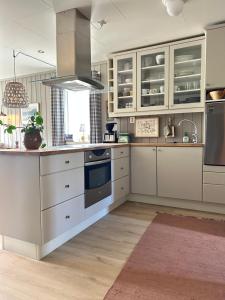 a kitchen with white cabinets and a stove at Mountain apartment in Vaga