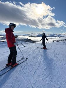 two people standing on skis in the snow at Mountain apartment in Vaga
