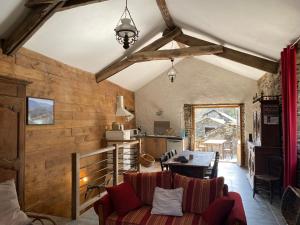 a living room with a couch and a table at La grange de Jean et Claude in Barre-des-Cévennes