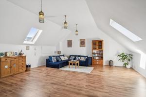 a living room with a blue couch and a table at Natururlaub Eifel-Mandala Feriewohnung in Kall
