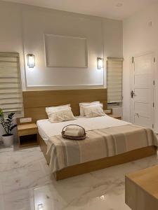 a bedroom with a bed with a bag on it at Trinity Villa Home Stay in Idukki
