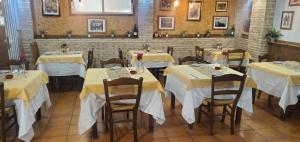 a dining room with tables with yellow table cloth at ThE MATADOR in Mocejón