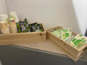 two wooden boxes filled with paper towels and toiletries at NOGA rooms in Porto Cesareo