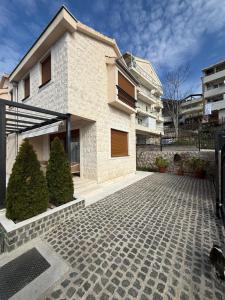 a house with a brick driveway in front of it at Villa Serenity Budva in Budva