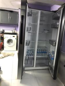 an open refrigerator filled with lots of water bottles at homestay Huynh DC in Ho Chi Minh City