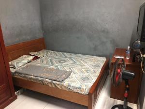 a small bedroom with a bed and a table at homestay Huynh DC in Ho Chi Minh City