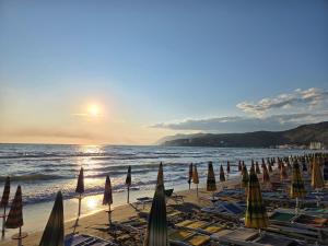 a group of umbrellas and chairs on a beach at U laguny 404 in Shëngjin