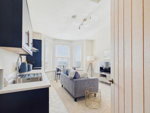 a living room with a couch and a kitchen at Southbourne beach in Southbourne