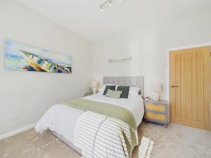 a bedroom with a bed and a painting on the wall at Southbourne beach in Southbourne