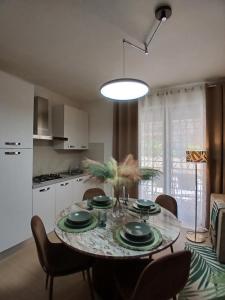 a kitchen with a table with chairs and a dining room at Fantasticasa in Nettuno