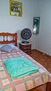 a bedroom with a bed and a fan on a table at Carioca Lapa Hostel in Rio de Janeiro +24 photos