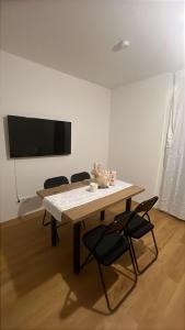 a table with chairs and a teddy bear sitting on top of it at Aurora Apartment in Vienna