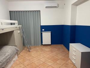 a bedroom with a bunk bed and blue walls at Villa Lidia & Attico degli artisti, free pets , giardino recintato e attrezzato in Minturno +103 photos