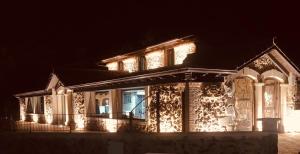 a house decorated with christmas lights at night at La Quinta Luxury Palace in Arnuero