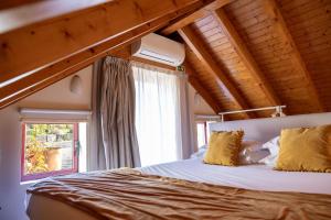 a bedroom with a large bed with yellow pillows at Peso Village in Amarante +146 photos