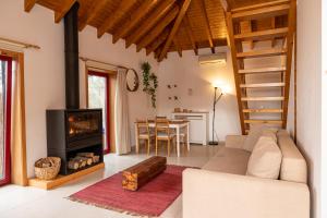 a living room with a couch and a fireplace at Peso Village in Amarante