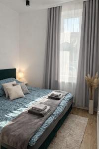 a bedroom with a bed with towels on it at Apartamenty na Witosa in Nowa Sól
