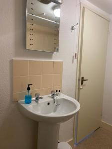 a bathroom with a sink and a mirror at The Phelips Arms in Montacute