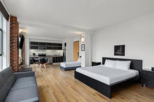a hotel room with a bed and a couch at The Haas, Trademark Collection by Wyndham in Los Angeles