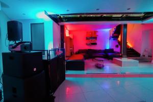 a living room with pink and blue lights at Manoir Loft pour vos événements in Nanterre