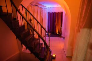 a hallway with a spiral staircase with purple lights at Manoir Loft pour vos événements in Nanterre +14 photos