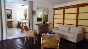 a living room with a couch and chairs at Moorea - Temae Reef Cottage in Temae