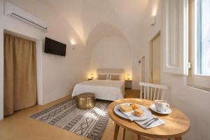 a bedroom with a bed and a table with bread on it at B&B Palazzo Boccaccio in Matino
