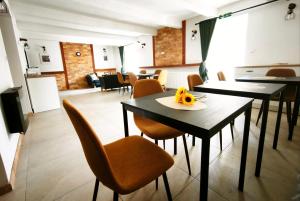 a dining room with tables and chairs with a plate of fruit on it at Vila Olivín - Private rooms with bathroom in Banská Bystrica