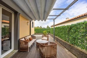 a patio with a table and chairs on a deck at Cozy Haven Santana - Nature & Hiking Trails in Santana