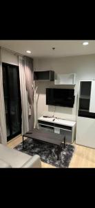 a living room with a couch and a coffee table at Perfectly Located Airport Link Train City Access in Bangkok